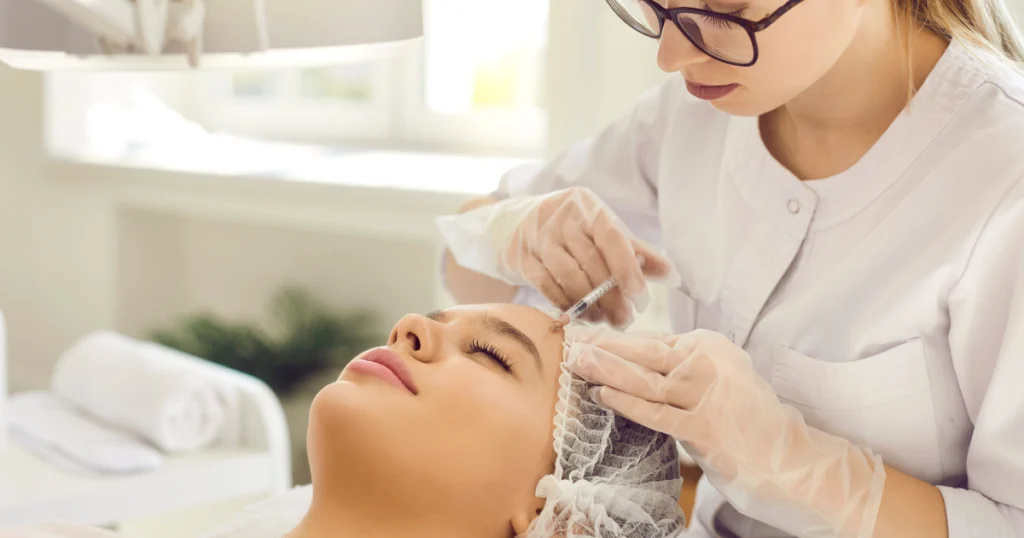 Woman receiving Sculptra facial injection by specialist in Charleston, SC clinic